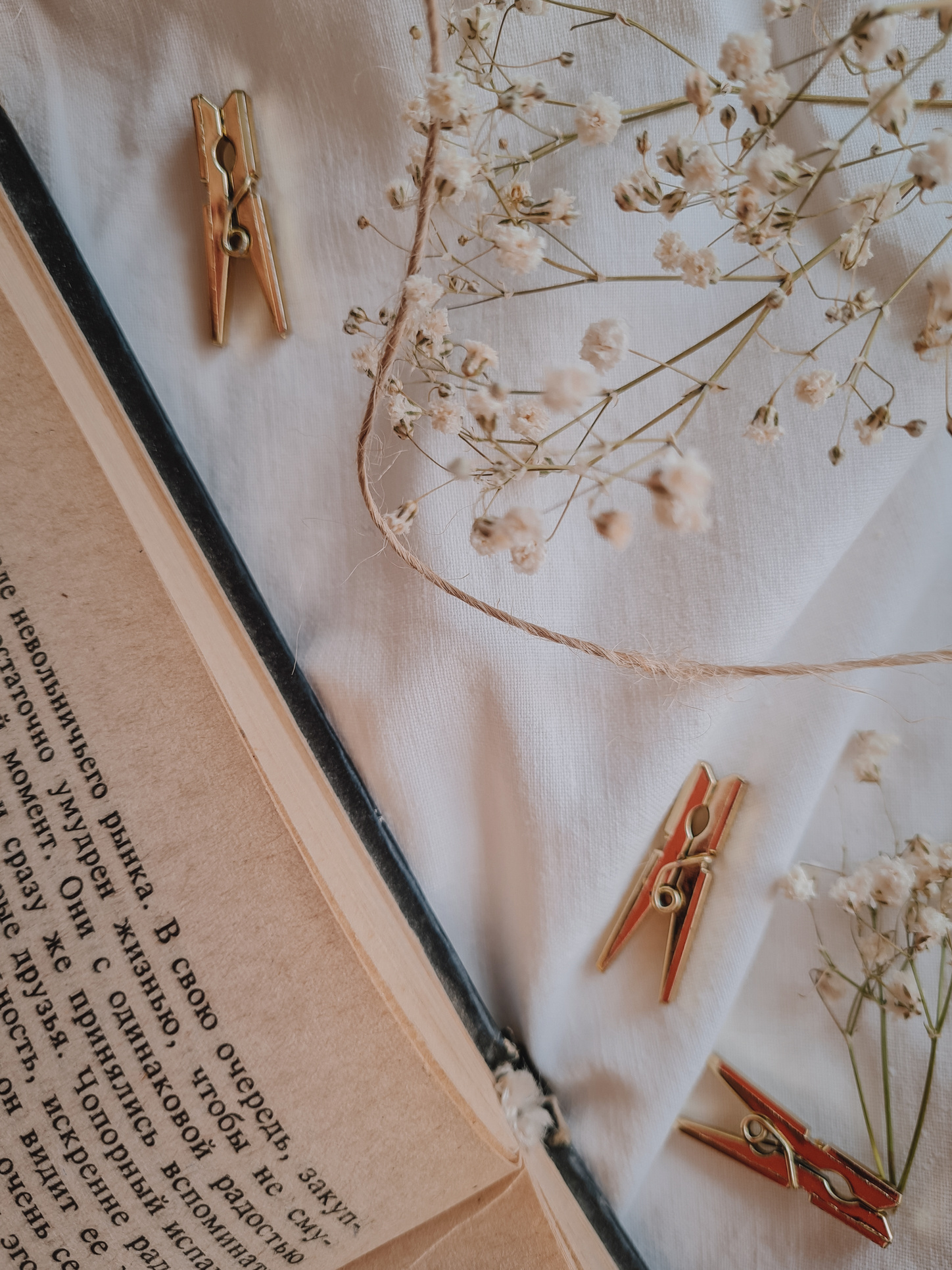 Gold and Silver Necklace on White Textile